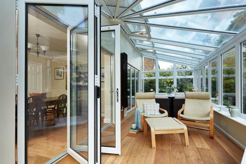 white upvc harmony lean to victorian conservatory with bifold doors Matson4162